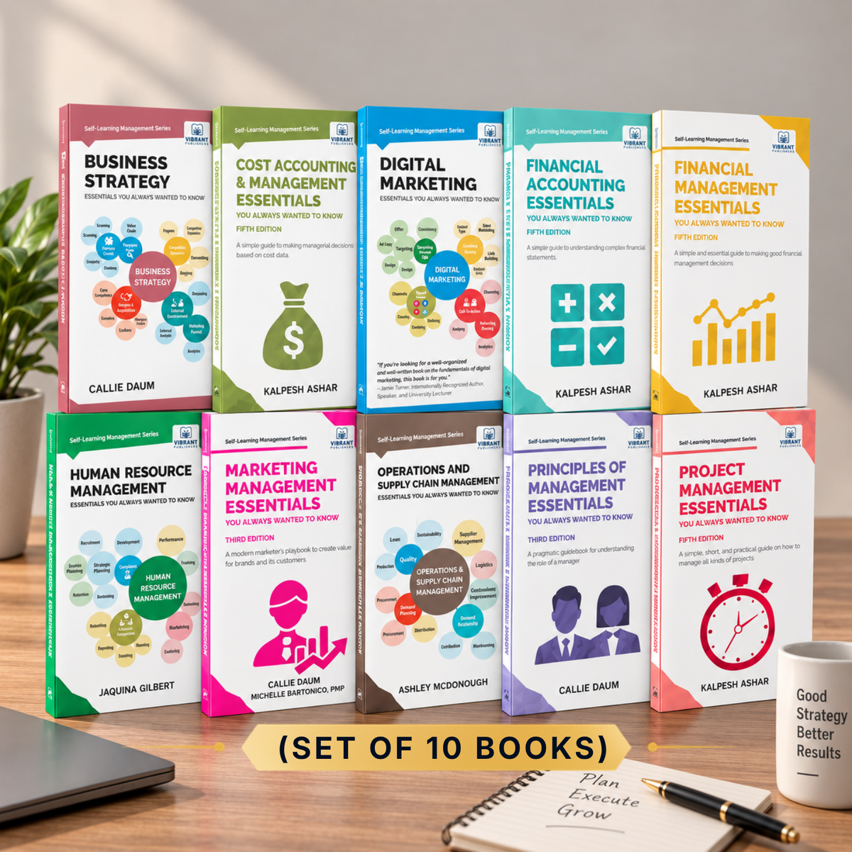 A set of 10 business and management books arranged in a 2x5 grid on a desk. The books feature colorful covers with titles such as Business Strategy, Cost Accounting & Management Essentials, Digital Marketing, Financial Accounting Essentials, Financial Management Essentials, Human Resource Management, Operations and Supply Chain Management, Principles of Management Essentials, and Project Management Essentials.