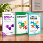 Three paperback books from the Self Learning Management Series by Jaquina Gilbert are displayed on a wooden table. The set includes 'Diversity in the Workplace Essentials' with a purple and white cover, 'Human Resource Management' with a green and white cover, and 'Leadership Essentials' with a teal and white cover.