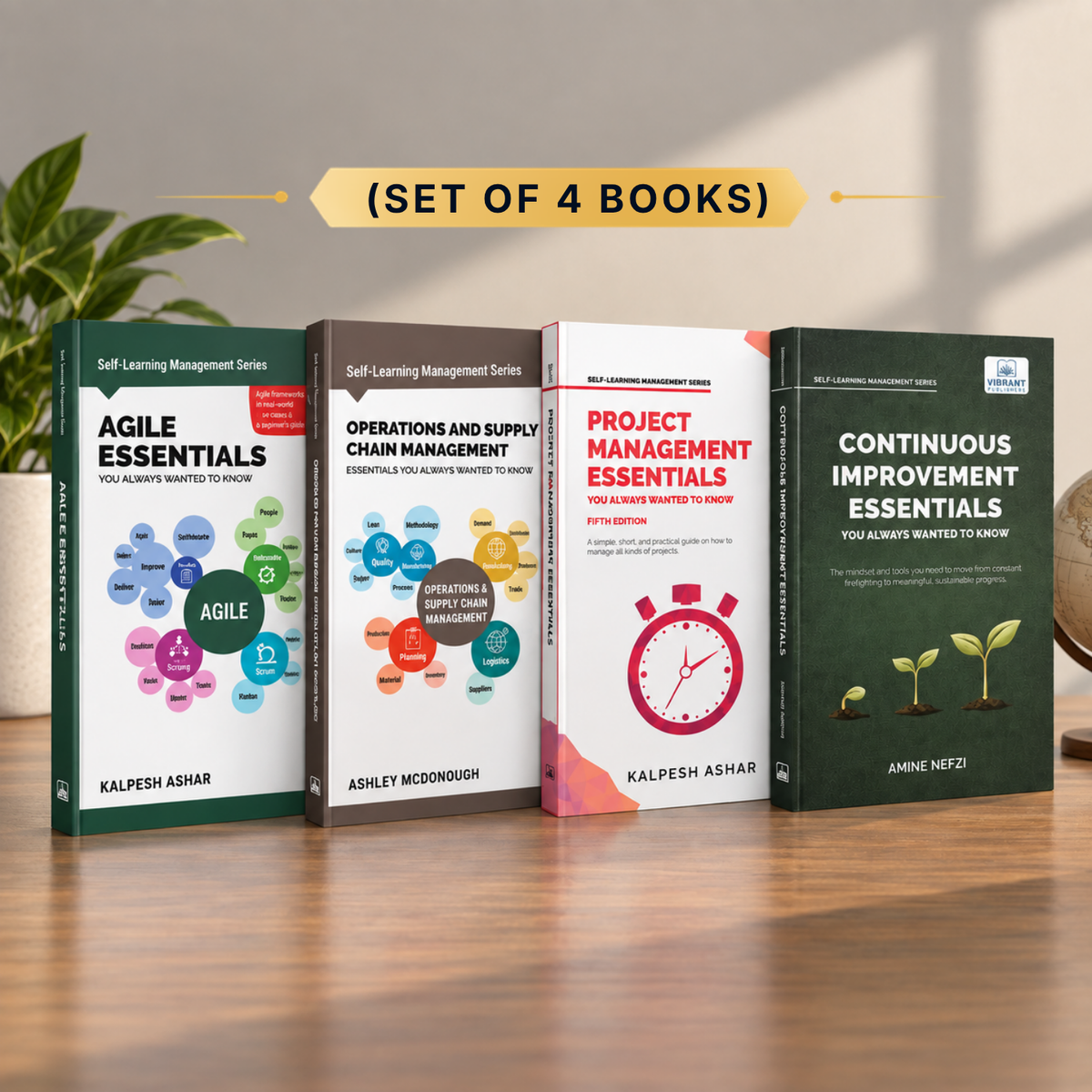 Four paperback books from the Self Learning Management Series arranged in a row on a wooden table, with a decorative plant and globe in the background. The books are titled 'Agile Essentials', 'Operations and Supply Chain Management Essentials', 'Project Management Essentials', and 'Continuous Improvement Essentials'.