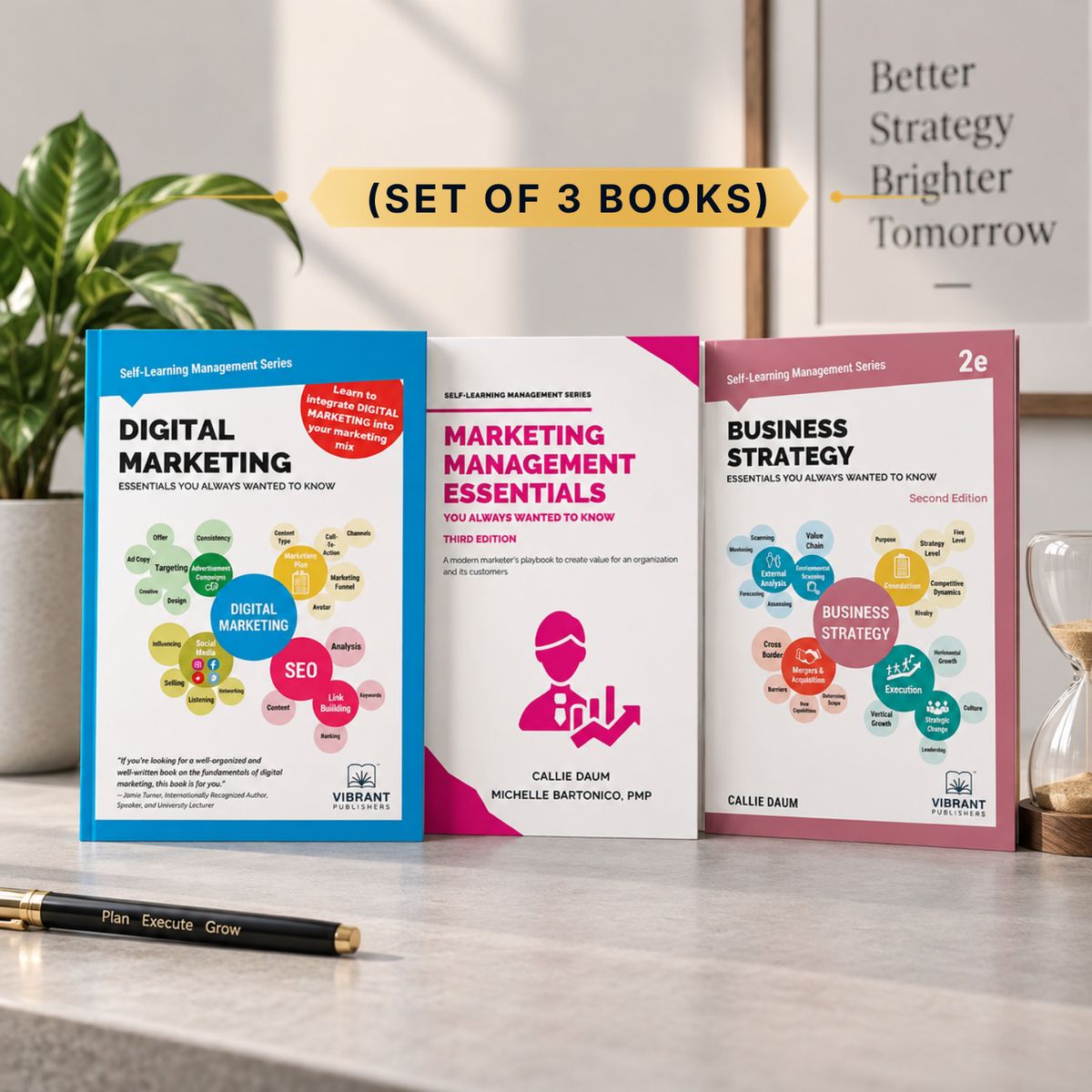 Three paperback books titled Financial Management Essentials, Cost Accounting & Management Essentials, and Financial Accounting Essentials by Kalpesh Ashar are displayed on a wooden desk. 