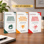 Three paperback books standing upright on a wooden desk: Business Statistics Essentials by Bianca Szasz, Business Intelligence Essentials by Irene Tobajas, and Business Analytics Essentials by Riyanka Jain. 
