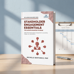 A paperback book titled 'Stakeholder Engagement Essentials' by Michelle Bartonico, PMP, standing upright on a light wood desk. 
