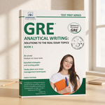 GRE Analytical Writing Book 1 by Vibrant Publications, featuring a clean white cover with green and teal text, a circular 'Updated for the shorter GRE' badge, and a photo of a smiling woman holding books on the front. The book stands upright on a light wooden surface with a softly blurred indoor background.