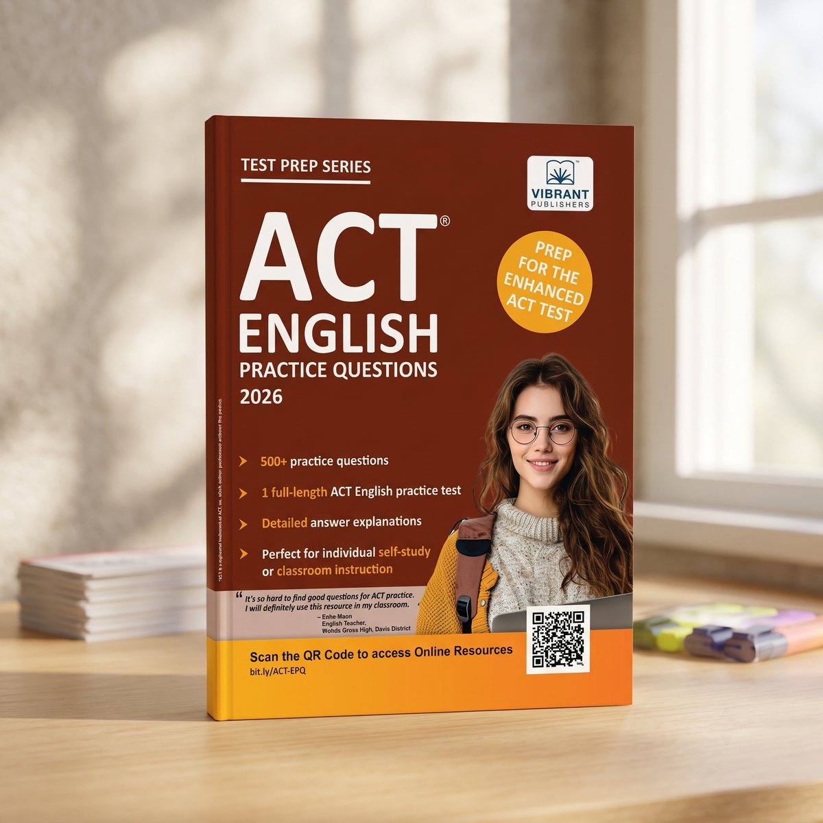 A paperback book titled "ACT English Practice Questions 2026" by Vibrant Publications stands open on a wooden desk. 