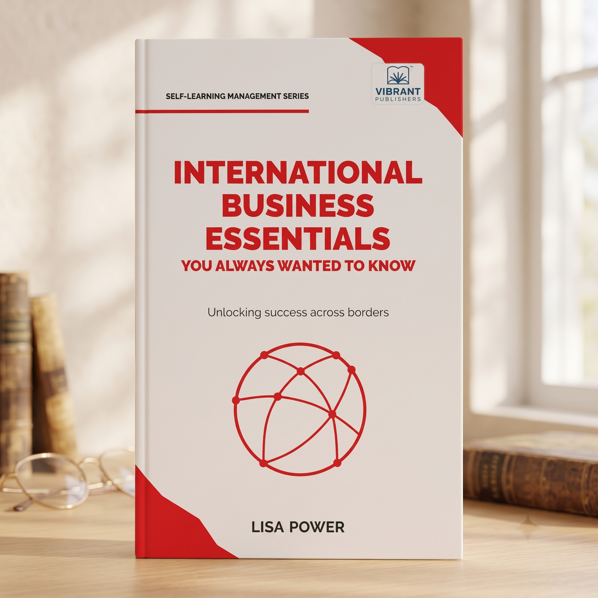 A book titled "International Business Essentials: You Always Wanted to Know" by Lisa Power stands upright on a wooden surface..
