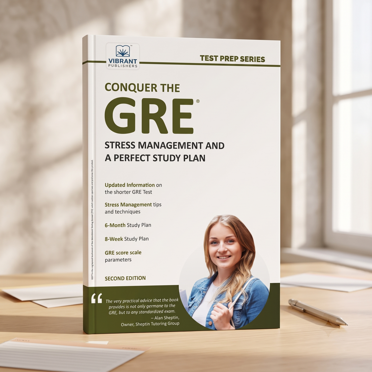 A hardcover study guide book titled 'Conquer the GRE: Stress Management and a Perfect Study Plan' by Vibrant Publications, standing upright on a wooden desk with a blurred study room background.