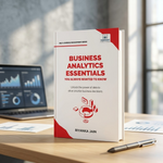 A paperback book titled 'Business Analytics Essentials' by Riyanka Jain stands upright on a wooden desk.
